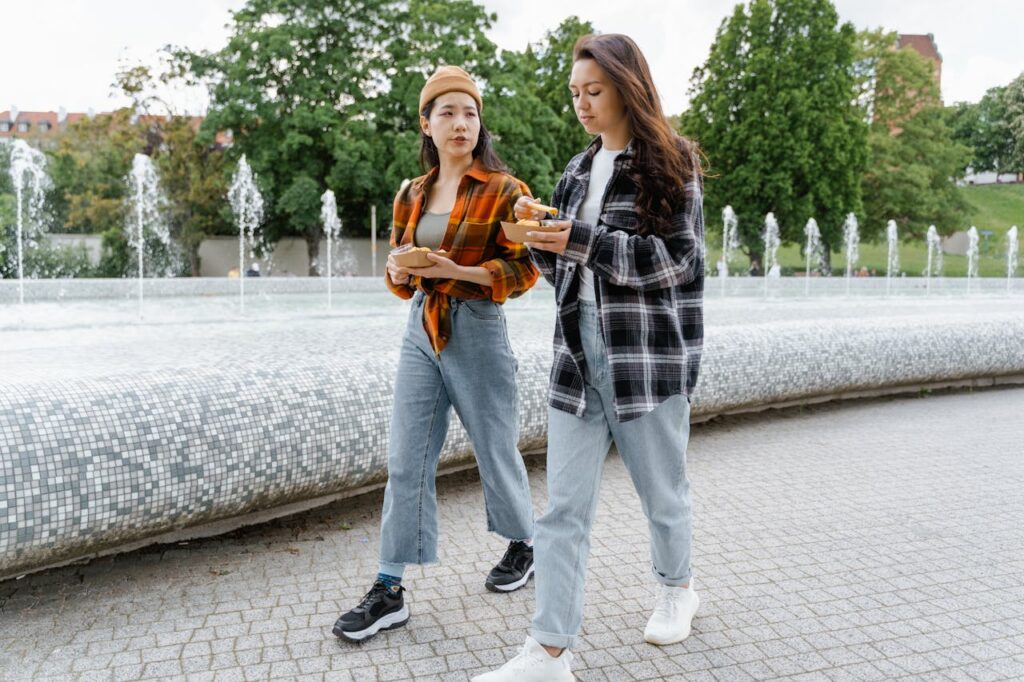 women-eating-while-walking-at-the-park-8165236 Women Eating while Walking at the Park
